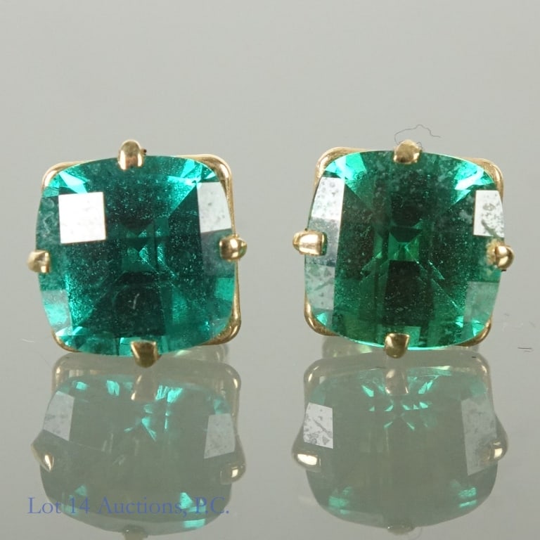 14k Y. Gold Emerald(?) Earrings: Pair of 14 karat gold earrings (marked "14k" on the backs and on the stems. Stemas also marked with an "infinity" loop symbol. Large green stones test close to emerald on our electronic tester, but ar