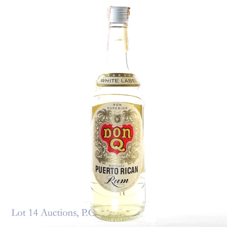 1960s Don Q White Label Puerto Rican Rum: Don Q White Label Puerto Rican Rum, 80 Proof, 4/5 Quart, early 1960s- late 1970s tax strip with "62" glass molding. Small tear in tax strip but overall intact and in fair condition.