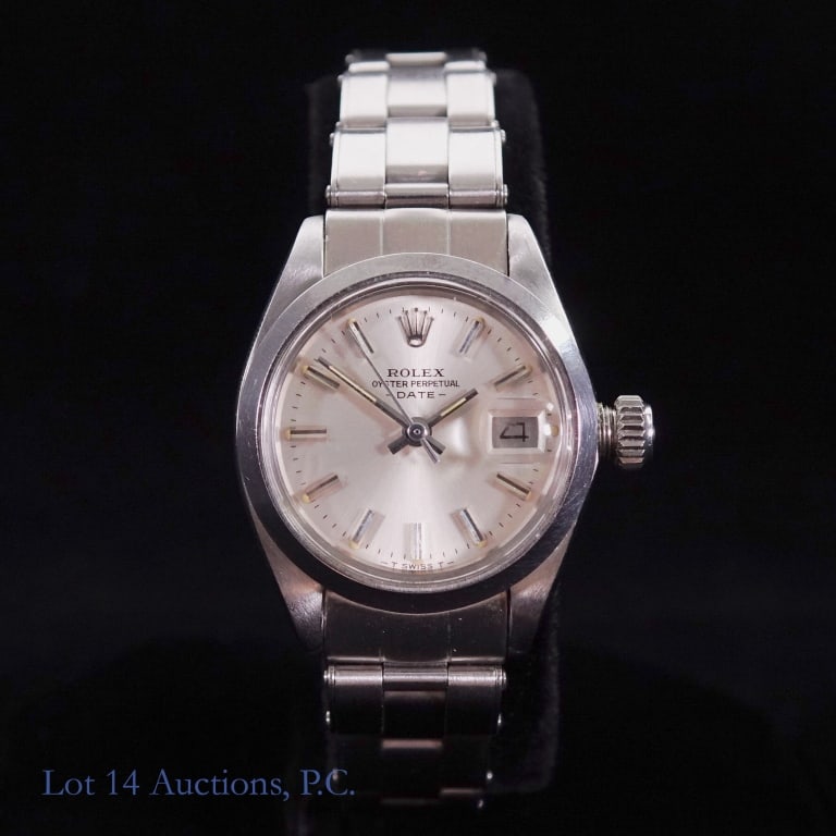 Ladies Rolex Oyster Perpetual Date Watch: Ladies Rolex Oyster Perpetual Date Watch. Sticker on back #6916. Rolex band #6634 with Rolex, Steelinox and Swiss Made. Watch running. 99 or 66 where band connects to case. Light scuff on band and cas