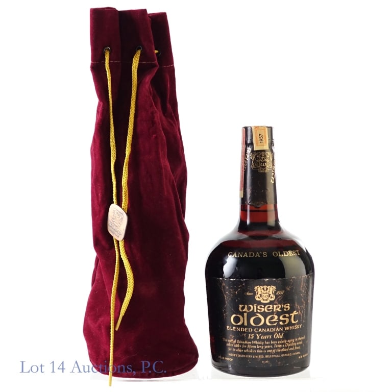 1957 Wiser's Oldest 15 Year Canadian Whisky: Wiser's Oldest 15 Year Blended Canadian Whisky, 80 Proof, 4/5 Quart, Distilled: 1957, Registered Bottle #U110886. Tax strip torn in multiple places but intact overall and in fair condition. Original r