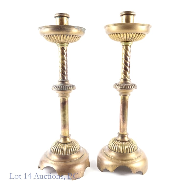 Early 20th c. Brass Memorial Candlesticks: Pair of brass candlesticks. 17.25" tall. Base approximately 6" diameter. 5.7 pounds and 5.9 pounds. The base of one is engraved "In memory of Jane Amelia Douglass at rest Feb 15, 1902". The other base