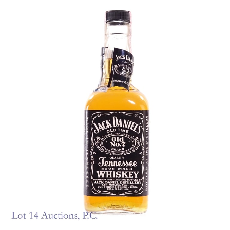 "83" Jack Daniel's Tennessee Whiskey (500 ml): Jack Daniel's Tennessee Whiskey, 90 Proof, 500 ml, early 1980s tax strip, "83" glass molding. Tax strip in very good condition with little to no tears. Plastic seal around bottle neck broken.