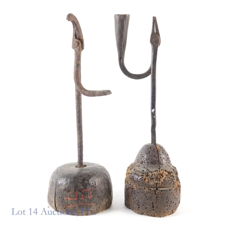 Hand Forged Iron Rush Light Holders (2): Hand Forged Iron Rush Light Holders (2) A pair of wrought iron rush light holders with wooden bases, one with candle holder. Both stand 11.5" tall. One item includes accession numbers. Both bases inta