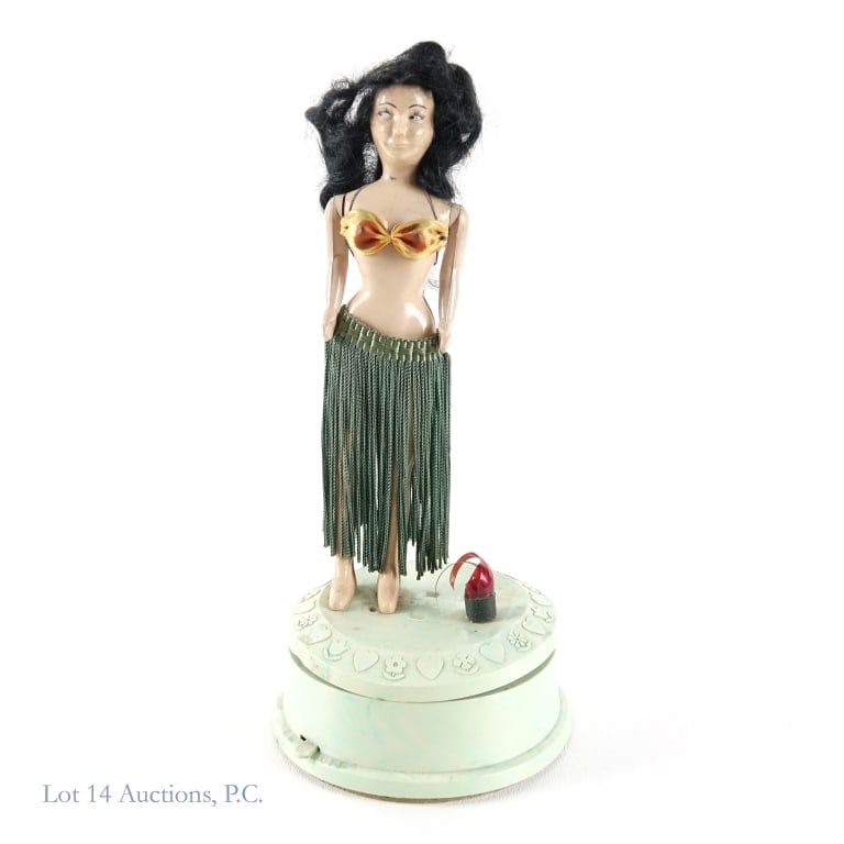 Suspicious Twirling Hula Girl Musical Doll: Suspicious Twirling Hula Girl Musical Doll. 10" x 4.5" twirling musical hula girl doll with suspicious side eyed glance. Arms of doll are movable. Aloha Oe plays as stand spins. Swiss musical movement