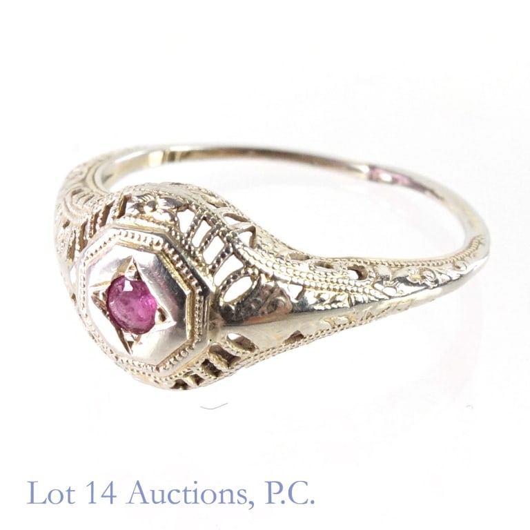 16 / 18k Y & W Gold Amethyst Ring: Yellow and white gold ring with small gem stone (electronically tests as amethyst). Ring is marked "18k", and tests electronically at 16 karat gold. Size 4.5. Total weight: 1.15 grams.
