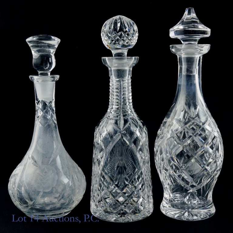 Wine Crystal / Glass Decanters - 2 Waterford +1: Two Waterford crystal wine decanters and one unmarked cut glass decanter. All have correct stoppers. Unmarked decanter has white residue on inside. Waterford decanters are approx. 13" tall, with stopp