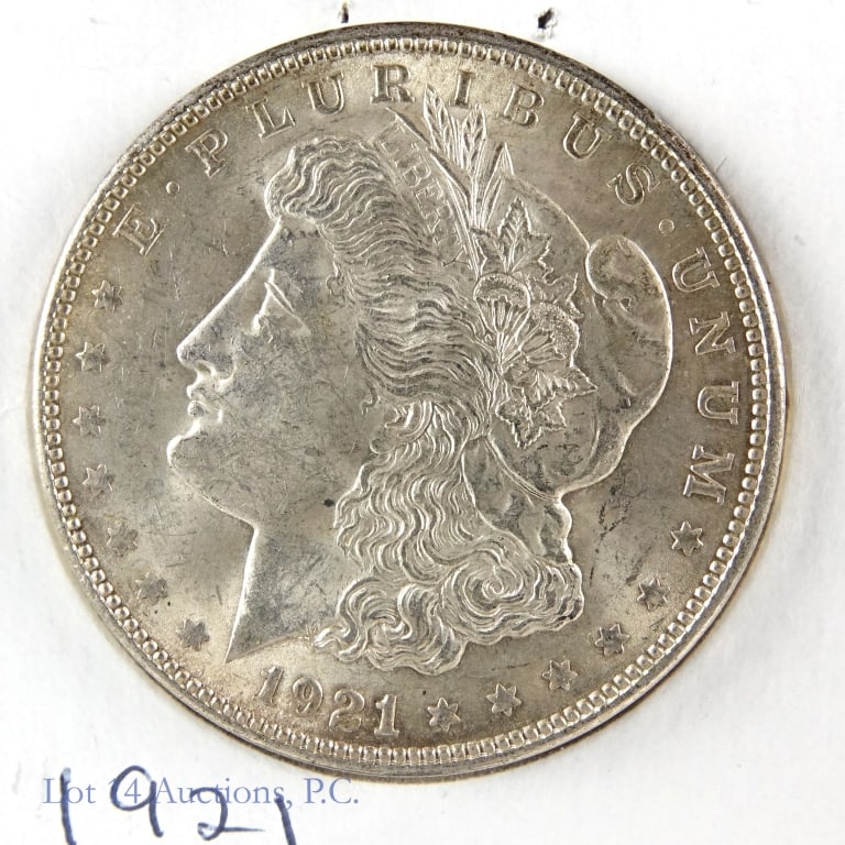1921 Silver Morgan Dollars (CH BU): 1921 silver Morgan dollar (Philadelphia Mint). Designer is George T. Morgan. Per consigner, grades CH BU. Metal is 90% silver, weighs 26.73 grams and measures 38.1 mm each coin. Mintage is 44,690,000 