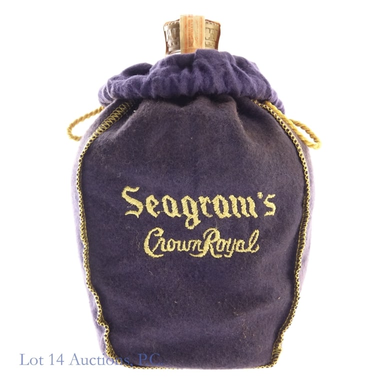 1967 Crown Royal Fine De Luxe Canadian Whisky: Crown Royal Fine De Luxe Blended Canadian Whisky, 80 Proof, 750 ml, Distilled: 1967. Tax strip in fair condition with minor tears, one strip is loose but still attached. Bag included.