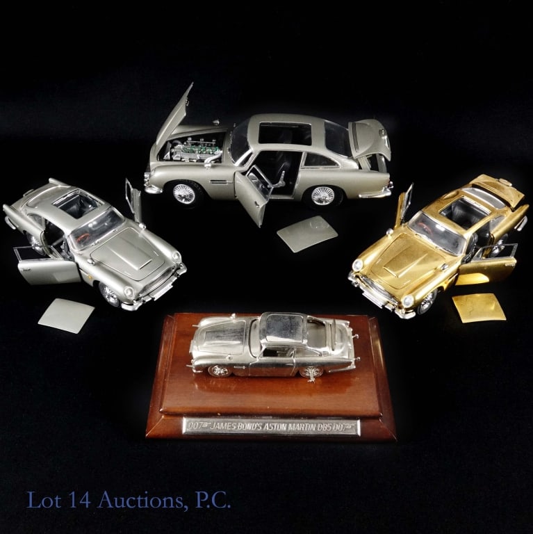 James Bond Aston Martin Model Collection (4): 4 examples of James Bond's Aston Martin automobile. Condition varies. Sold as is. 2014 Mattel Hot Wheels Aston Martin DB5. Doors open. Rear bulletproof screen is retractable. Approximately 10.5" long.
