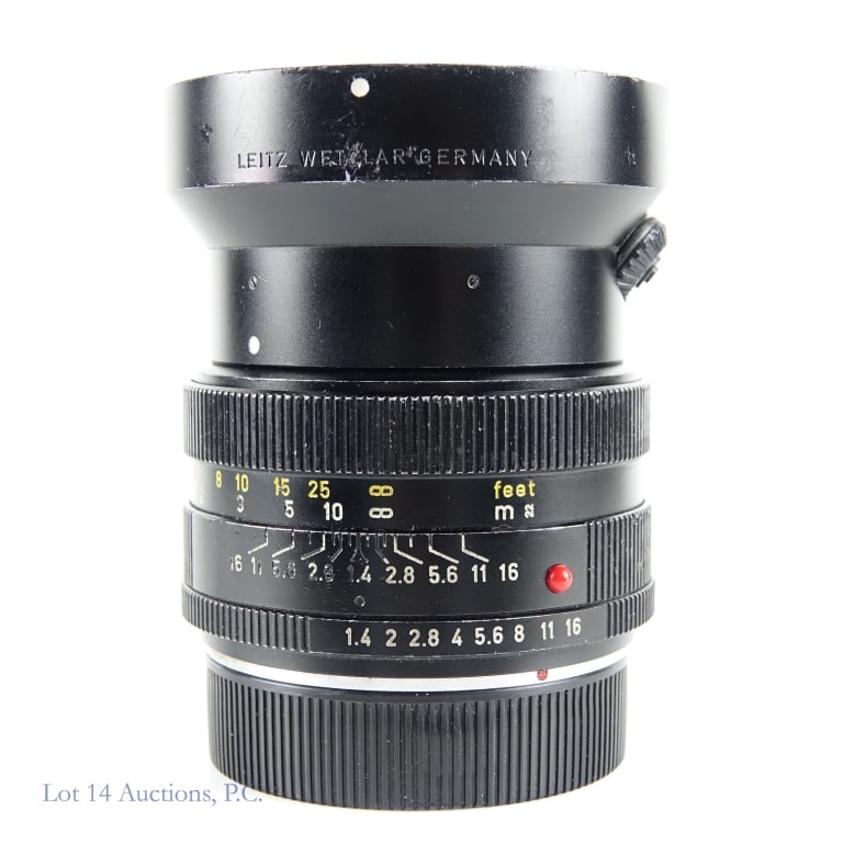 Leitz Summilux-R, 50mm, F1:4 Lens w/ Sunshade: Leitz Summilux-R, 50mm, F1:4 Lens w/ Sunshade. Leitz Wetzlar #2493028 Summilux-R 1:1.4 / 50mm lens with Leitz sunshade. Sunshade bent and dinged. Wear on focus ring appropriate with use. See photos fo