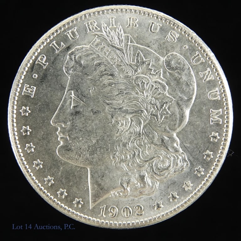 1902-O USA Silver Morgan Dollar (BU): 1902-O silver Morgan dollar (New Orleans Mint). Designer George T. Morgan. Per consigner, grades BU with decent luster in the fields. Metal is 90% silver, weighs 26.73 grams and measures 38.1 mm. Mint