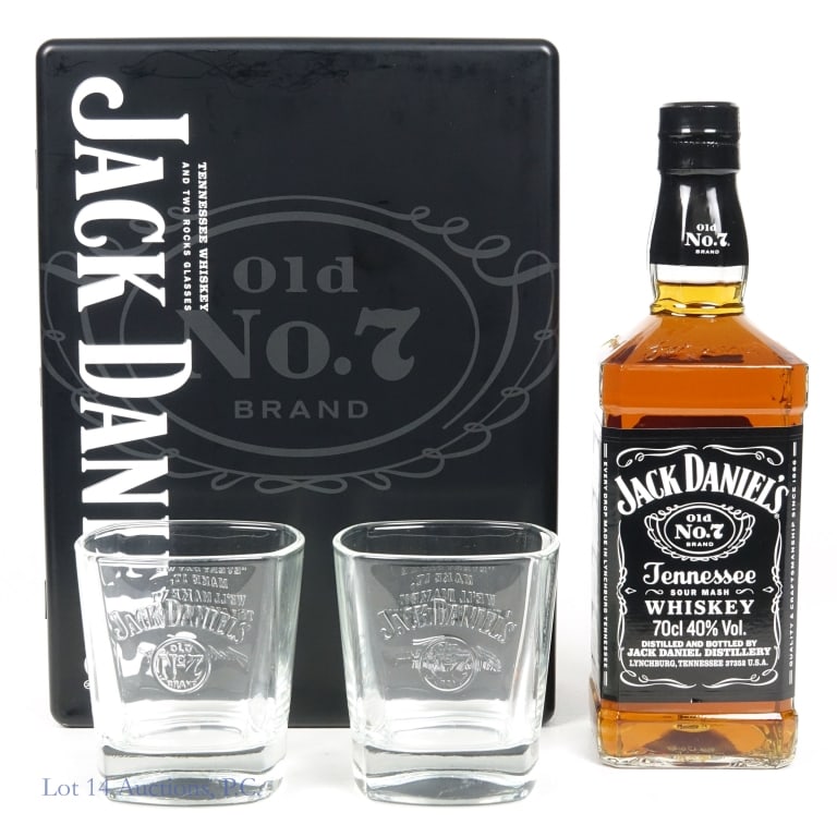 Jack Daniel's Tenn. Whiskey Gift Set & Tin: Jack Daniel's Tennessee Whiskey, 80 Proof, 700 ml, French Export. Gift set includes two custom Jack Daniel's glasses. Tin case included to house full set, front lid slightly dented.