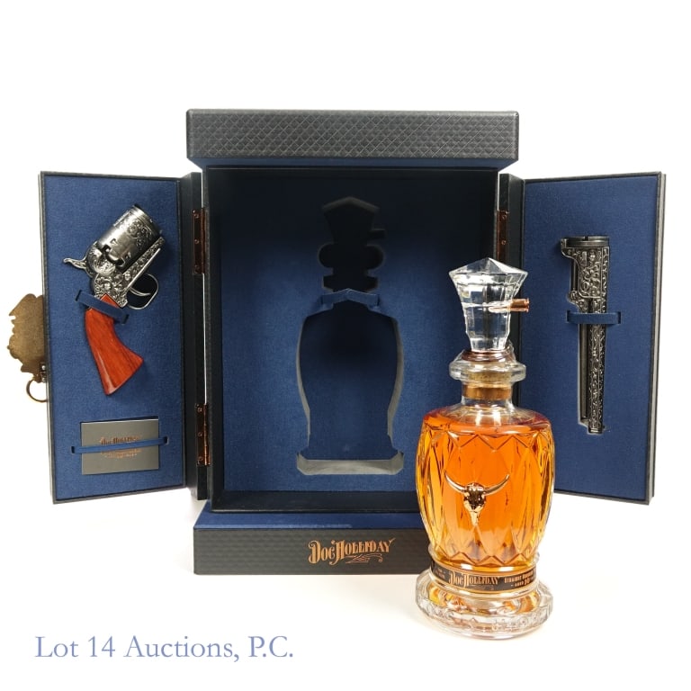 Doc Holliday 10 Year Special Edition Bourbon**: Doc Holliday 10 Year Special Edition Bourbon Decanter, 96 Proof, 700 ml. Crystal decanter also contains a revolver gun barrel piece, revolver cork handle piece****Plastic seal torn, not completely thr