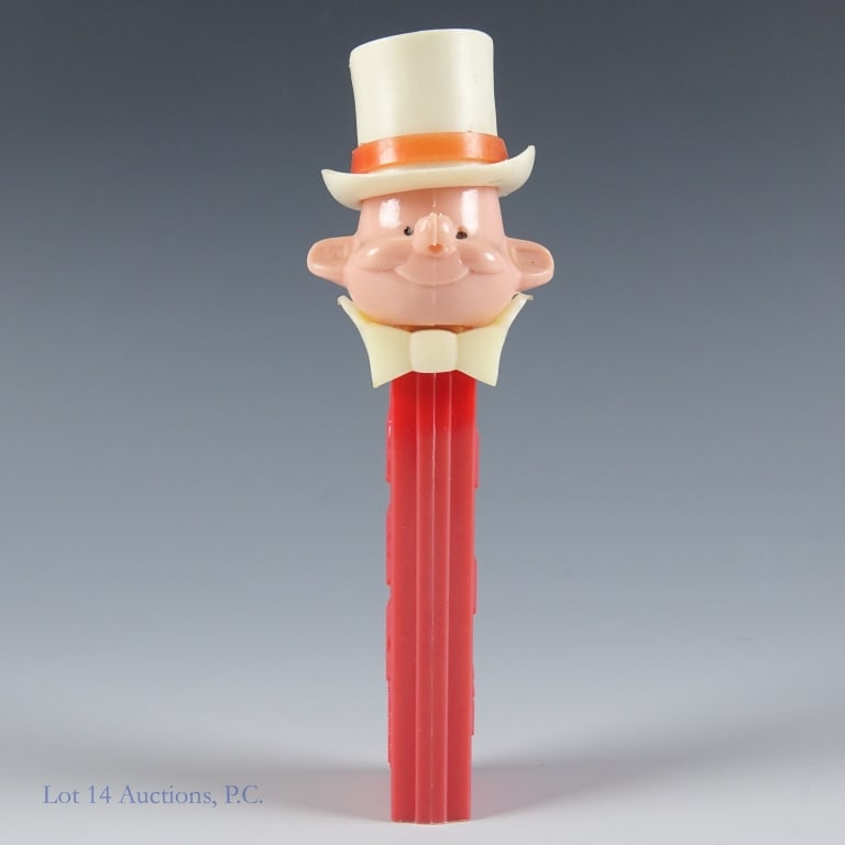 PEZ Dispenser, Ringmaster, 3.4, Austria: PEZ Dispenser, Ringmaster, 3.4, Austria. PEZ Ringmaster, No mustache, #3.410.455, Made in Austria, Red Stem, Spring working, Head loose, No feet, Light discoloration front of stem. See photos for more