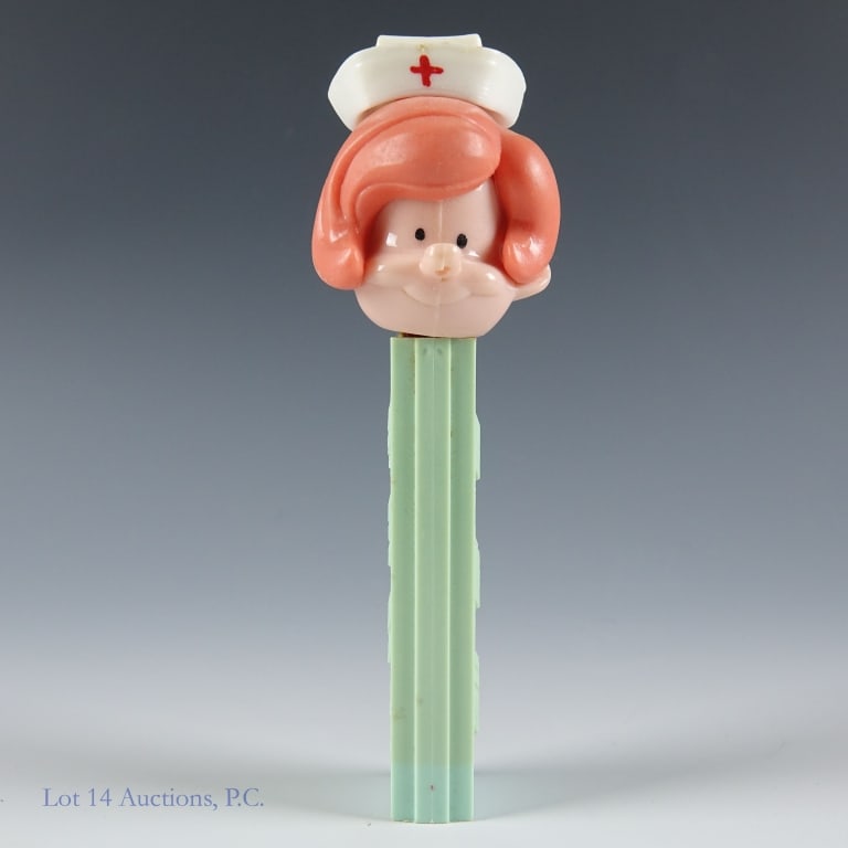 PEZ Dispenser, Red Hair Nurse, 2.6, Yugoslavia: PEZ Dispenser, Red Hair Nurse, 2.6, Yugoslavia PEZ nurse; Red hair; #2.620.061; Made in Yugoslavia; Light Green Stem; Spring working; Head stable; No feet; Light discoloration and scuffs on stem. See
