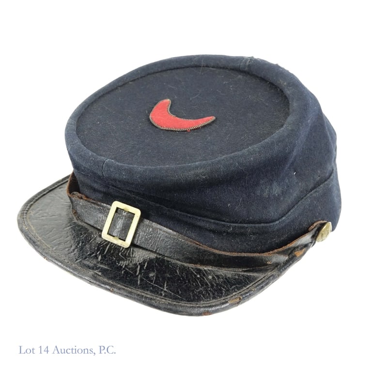 Indian Wars Kepi Cap (XI Corps): Kepi Cap from the Indian Wars era of United States history. Badge on top indicates XI Army Corps. Wire thread border. General wear has old repair to back of crown and museum mending tape on leather sw