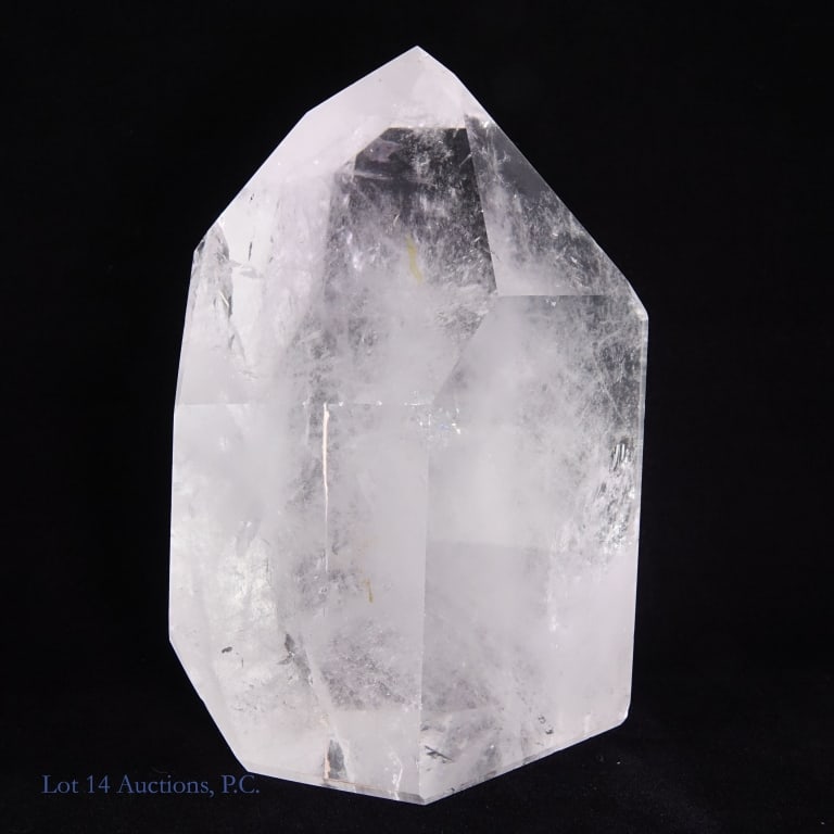 Clear Quartz Crystal Tower, 6.5", 4.4 Lbs.: Clear quartz crystal obelisk, approximately 6.5" in height and 12" around, weighing approximately 4.4 Ibs. 1" and 0.5" vertical cracks in quartz, unknown if this was natural made or if the crystal was