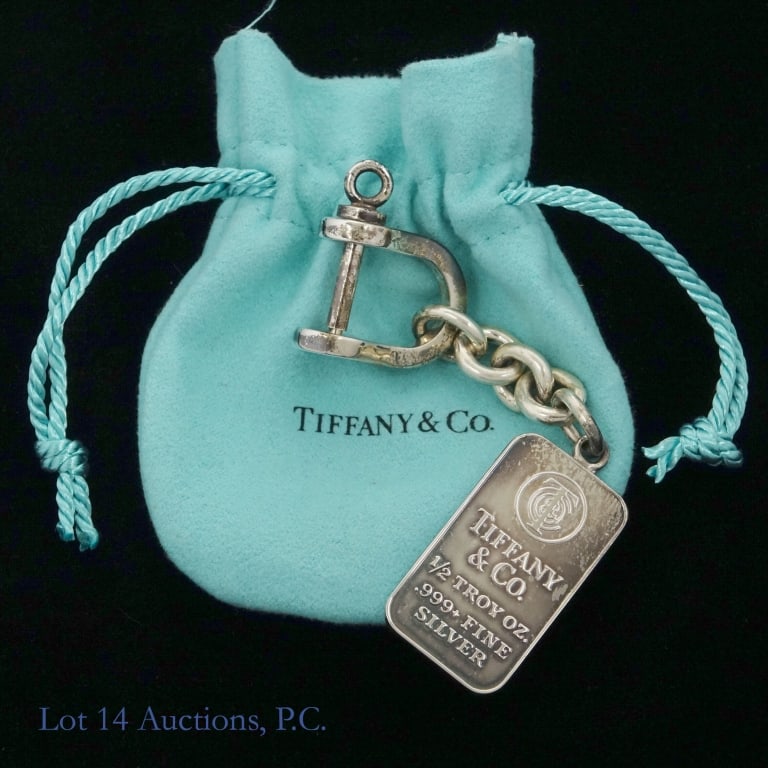 Tiffany & Co .5 ozt .999 Silver Bar Keychain: Tiffany & Company silver keychain. Bar is marked "Tiffany & Co. 1/2 troy oz. .999+ fine silver". Bar tests electronically as .999 silver. Chain and fob test electronically as 0.925 sterling silver. In