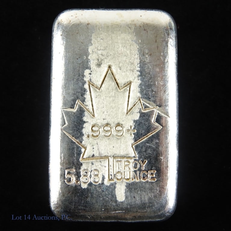 Maple Leaf 5.8 Ozt. 99.9% Silver Ingot: Silver ingot with maple leaf imprint and the number ".999+" inside it. Below the maple leaf imprint reads "5.88 troy ounce". Silver content confirmed on Lot 14 Auctions electronic metal verifier and w