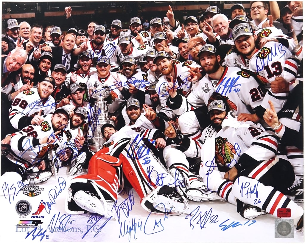 2013 Chicago Blackhawks Team Signed Picture: 20" x 16" color picture featuring the 2013 Stanley Cup Champion Chicago Blackhawks. We count the autographs of 22 people. Some of the people we have identified: Ben Smith (28), Nick Leddy (8), Michal 
