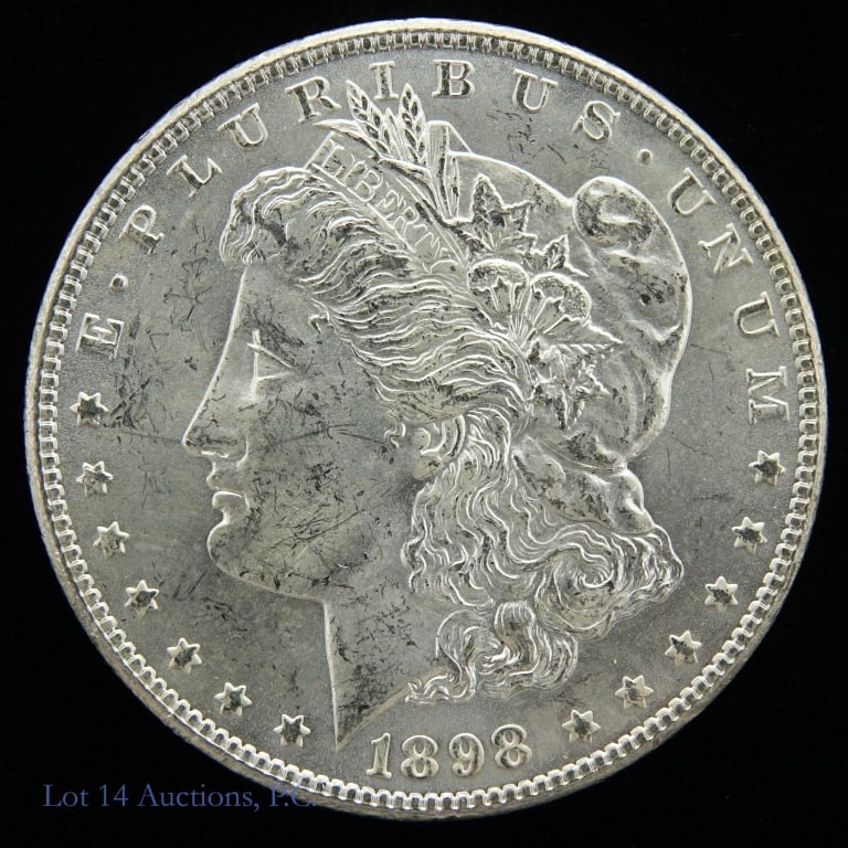 1898-O USA Silver Morgan Dollar (CH BU): 1898-O United States silver Morgan dollar (New Orleans Mint). Designer George T. Morgan. Per consigner, grades CH BU. Sealed in a Tangible Asset Management holder. Metal is 90%-silver, weighs 26.73 gr