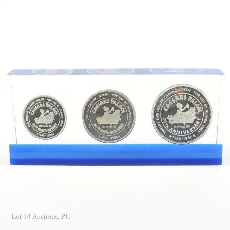 Caesar Palace USA 20th Ann Silver Gaming Tokens -3: Three (3) United States silver Caesars Palace - Las Vegas 20th anniversary gaming tokens dated 1966 to 1986 in Plexiglas display case with blue base. Metal is 99.9% silver with total ASW of 3.75 troy 