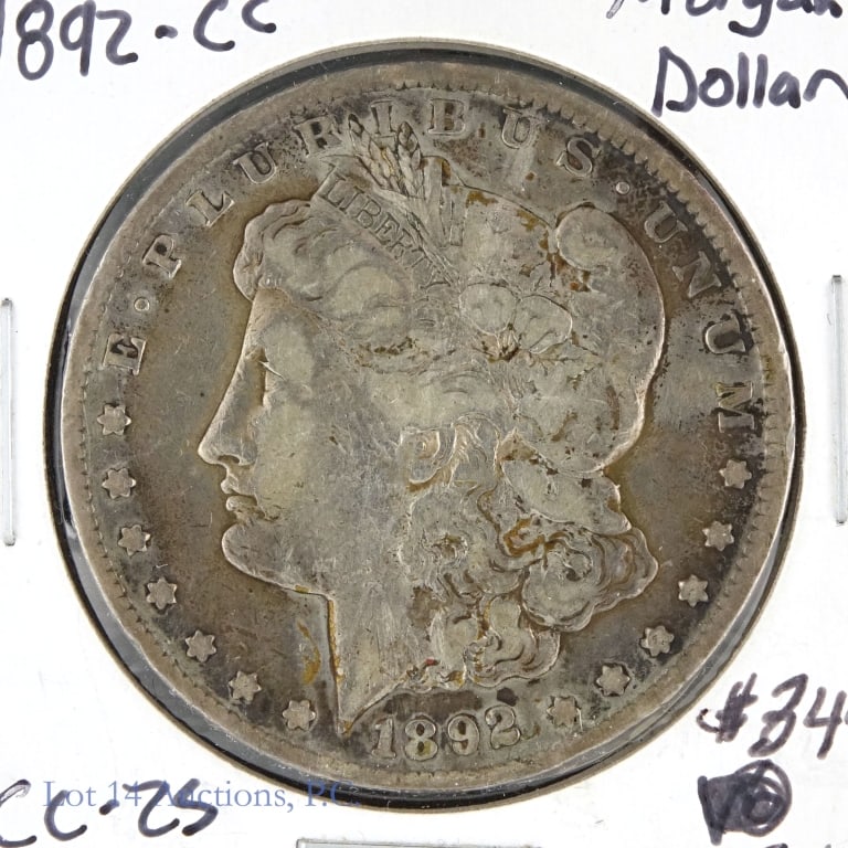 1892-CC USA Silver Morgan Dollar (F+): 1892-CC United States silver Morgan dollar (Carson City Mint). Designer George T. Morgan. Per consigner, grades F+ with toning around edges. Metal is 90%-silver, weighs 26.73 grams and diameter measur