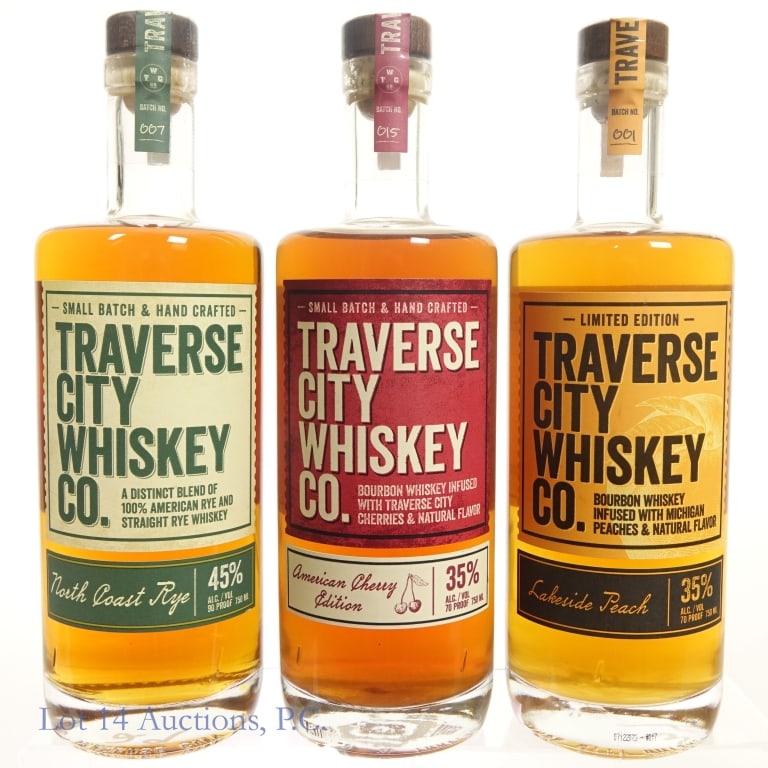 Traverse City Whiskey Co Trio - Bourbons, Rye (3)*: Three (3) bottles of Traverse City Whiskey Co. Whiskey. #1 - Small Batch, Hand Crafted American Chery Edition infused Bourbon Whiskey*, 35%abv, 750ml, batch 015. #2 - Lakeside Peach infused Bourbon Wh