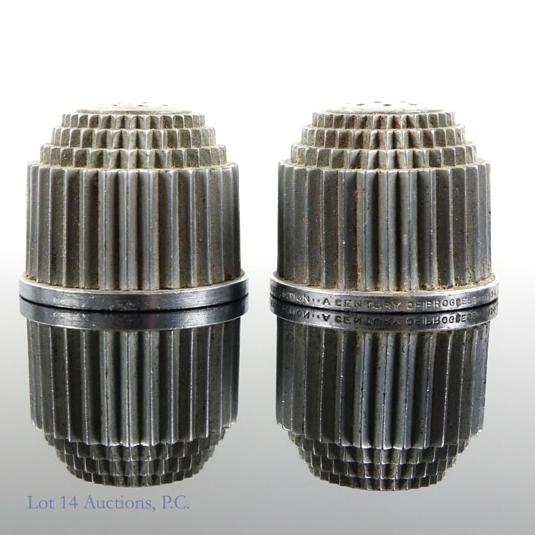 1934 World's Fair Ford Bldg. Salt & Pepper Shakers: Metal salt & pepper shakers from the 1933-34 World's Fair in Chicago. Base stamped "Ford Exposition ** A Century of Progress ** 1934". Scarce pair. Some wear. Scratches present on bottom.