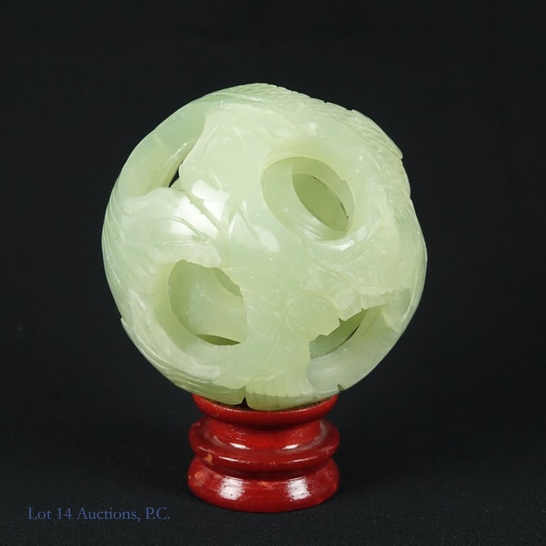 Jade or Jadeite Carved Chinese Puzzle Ball: Concentric sphere Puzzle ball believed to be jade or jadeite. Appears to have 4 layers and a small cube inside that layer. 12 holes in the outer layer. Approximately 3.25" diameter. Includes a small w