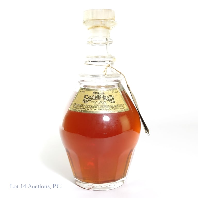 1976 Old Grand-Dad Bicentennial Bourbon Decanter: Old Grand-Dad Bicentennial Bourbon Decanter, 86 Proof, 4/5 Quart, "1976" glass molding. Very little piece of tax strip remains and is stained / faded. Neck tag and glass stopper included.