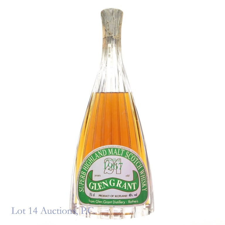 Glengrant 21 Year Scotch Whisky: Glengrant 21 year old Superb Highland Malt Scotch Whisky, distilled 1967, 80 Proof, 750 ml. The capsule is intact and tax strip is severely damaged and unreadable and very dirty.