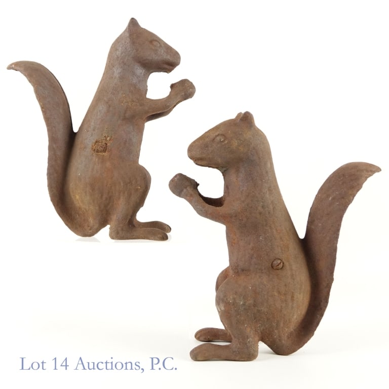 Vintage Cast Iron Squirrel Doorstops (2): Two 9'' tall squirrel figurines / doorstops, weighing about 4 pounds each. Evenly rusted, but otherwise good condition, even patina over whole piece.