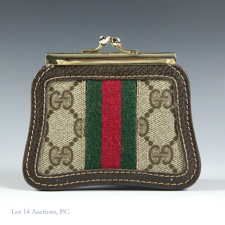 1980s Gucci Sherry Line Coin Purse: A Gucci Sherry Line coin purse with the iconic GG logo pattern, sherry stripes, and a kiss lock closing. Made of PVC leather. Measures approximately 3.25" x 4". There is a small bit of damage near one