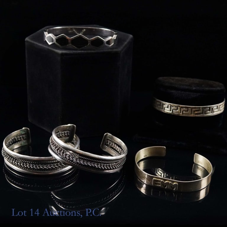 Sterling Silver Bracelets (5): Five sterling silver bracelets. One is a handmade Leonore Doskow piece with the initials EMM on the front. The next is a bracelet from Taxco, Mexico with a geometric design. It has a working clip, and
