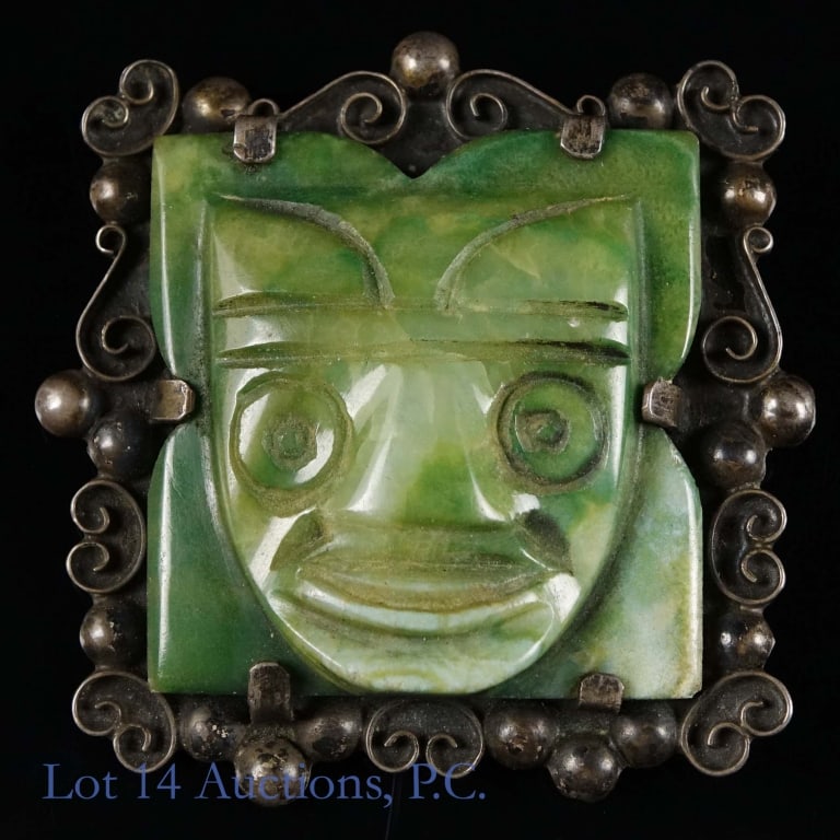 Mexican Jade and Sterling Vintage Brooch: Jade and Sterling brooch, carved into the shape of a smiling face. Stamped on the back are the words "Silver" and "Mexico". Weighs about 49g.