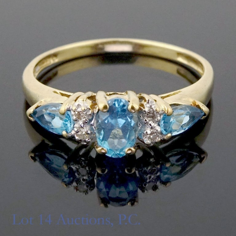 10k Gold Ring with Diamonds and Blue Stones: Size 7 ring made with 10k gold. Three blue stones (possibly topaz, chrysoberyl, or spinel?) with four melee diamonds, two on each side. 1.8g. Good condition.