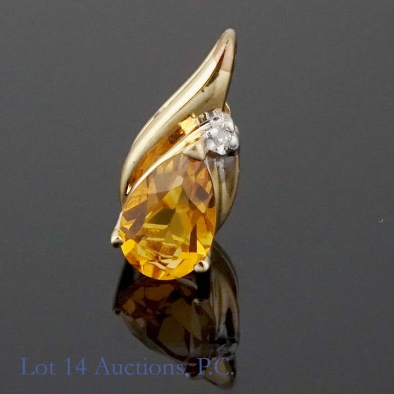 10k Gold Pendant with Diamond and Orange Stone: 0.75'' teardrop-shaped pendant made with 10k gold. A small diamond sits above a larger orange stone (possibly citrine, hessonite, or jadeite?). 1.18g. Good condition.