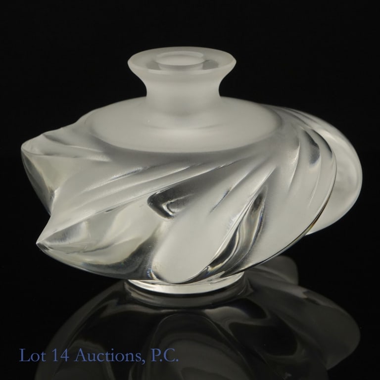 Lalique Samoa Crystal Perfume Bottle: Crystal perfume bottle with matching crystal stopper, in the Samoa design. No chips, cracks, or fleabites. Signed Lalique France on the bottom. 3.5'' tall (with stopper). 4'' at widest point.