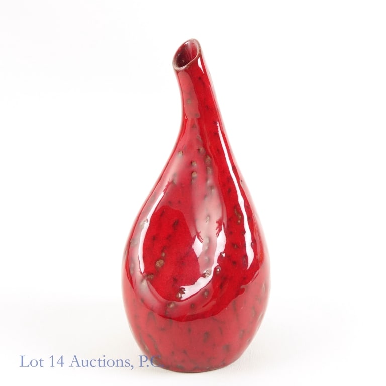 Richard Uhlemeyer Style Ceramic Vase: A red vase in the Richard Uhlemeyer style, likely from mid-20th century Germany. Vibrant red glaze spotted with brown. Measures about 8'' tall and 4'' wide. On the bottom is an orange sticker with the