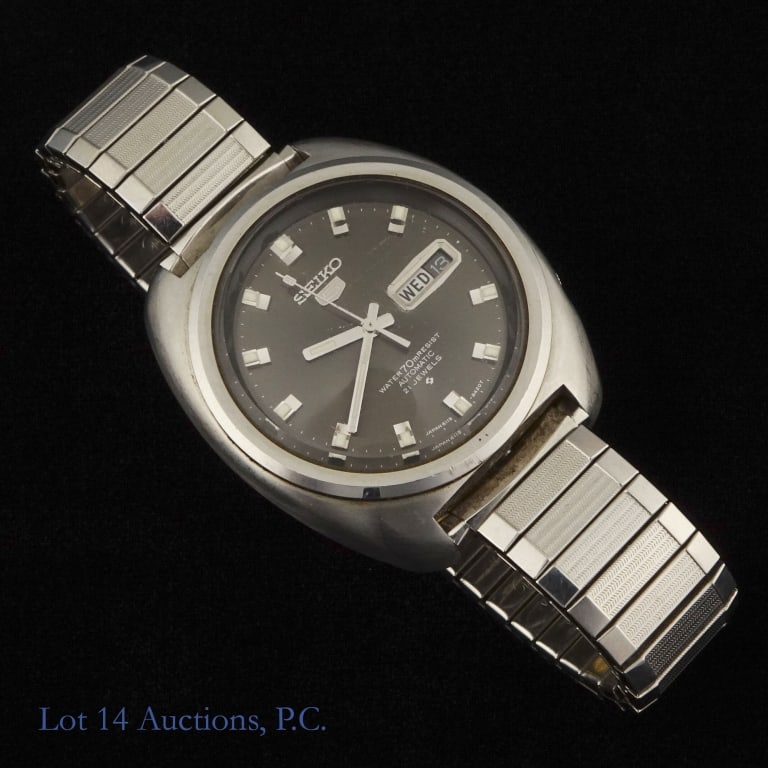 Vintage Seiko 21 Jewel Watch: Sturdy vintage watch from Seiko with a day/date feature at the 3:00 position. Stainless steel body and band. 21 jewels, water resistant, automatic. Numbered 6119-8400. Some scratching on the glass fac