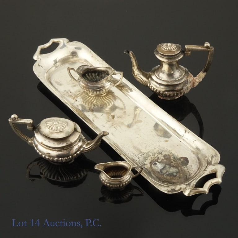 Asprey & Co Sterling Silver Mini Tea Set (5 pcs): Sterling Silver dollhouse tea set from Asprey & Co. Each piece has four marks on it: "A(M)&Co", an anchor, a lion, and a symbol that resembles an italicized T. Fair tarnishing on the largest piece and