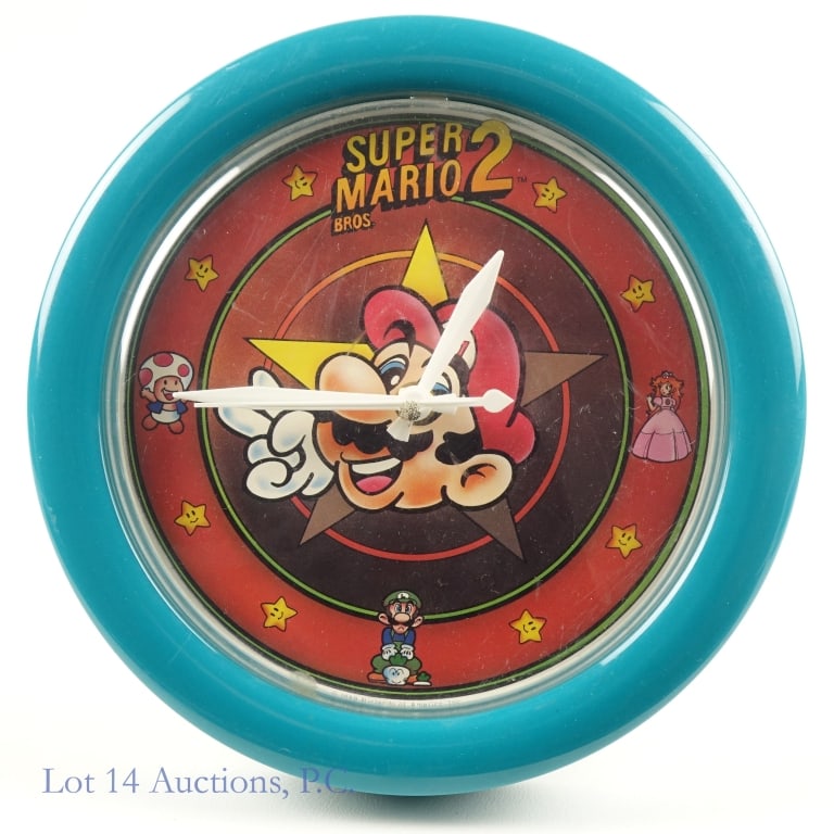 Vintage 1989 Super Mario Bros Wall Clock: Wall clock from the late 1980s from Nintendo of America promoting Super Mario Bros 2, featuring the title character alongside Peach, Luigi, and Toad. Clock has an 8.5'' diameter. It has some scratches