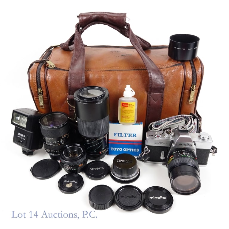 Minolta Camera Set and Accessories: Minolta Camera Set and Accessories. Lot is held in a Coastar brown leather camera bag, approx. 16" across, 8" wide, and 8" tall. Lot includes: Minolta SR-T 201 35mm film camera. Has CLC (contrast-ligh