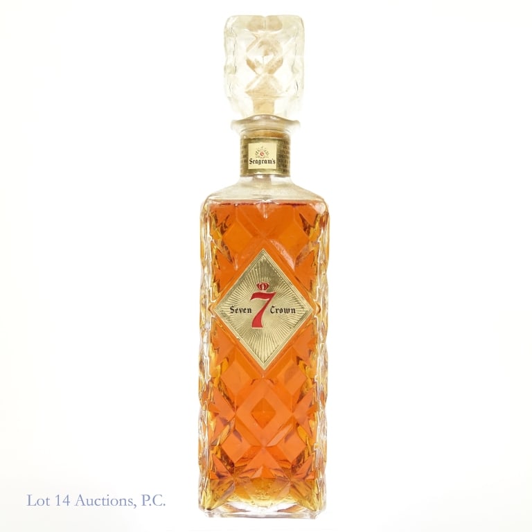 1960s Seagram's 7 Crown Whiskey (Cut Glass Decant): Seagram's Seven blended whiskey in a cut glass decanter. 86 proof. 4/5 quart. Series 112 (Internal Revenue) tax strip (1961 - 1977) with a "62" embossed on bottom of the bottle. Minnesota ax stamp is