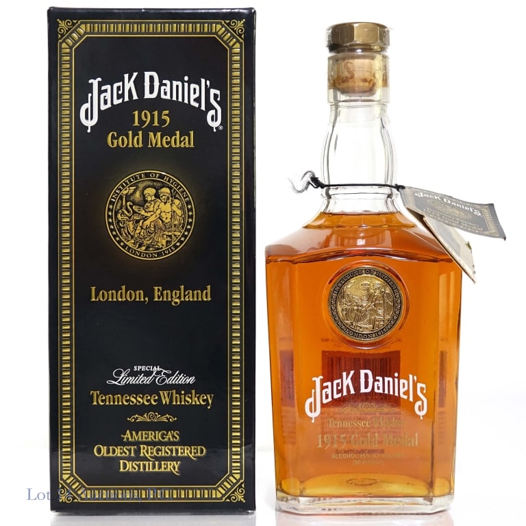 Jack Daniel's 1915 Gold Medal Tennessee Whiskey: Jack Daniel's 1915 Gold Medal London, England Tennessee Whiskey, 90 Proof, 750 ml, Box included. Bottle No. 096049. Signed by Master Distiller Jimmy Bedford, 2004. Appears to have a small part of anot