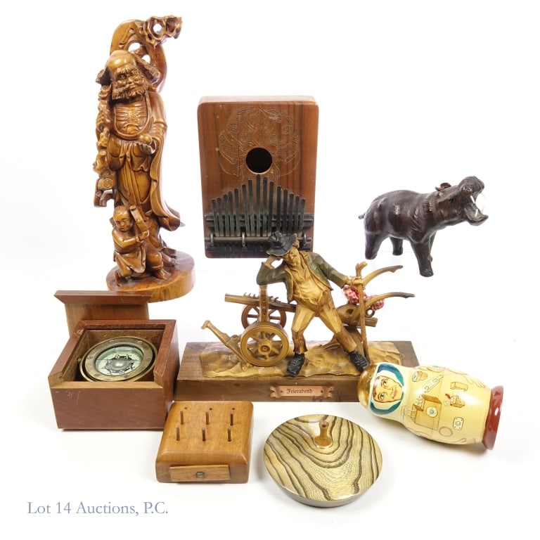 Wood Sculptures, Kalimba, Vase, Nesting Dolls, Etc. (8): Collection of various wooden items. Includes: A Chinese wood carving sculpture. Seems to be a depiction of a bearded man holding a staff over his shoulder. A smaller boy stands closely beside him. Mea