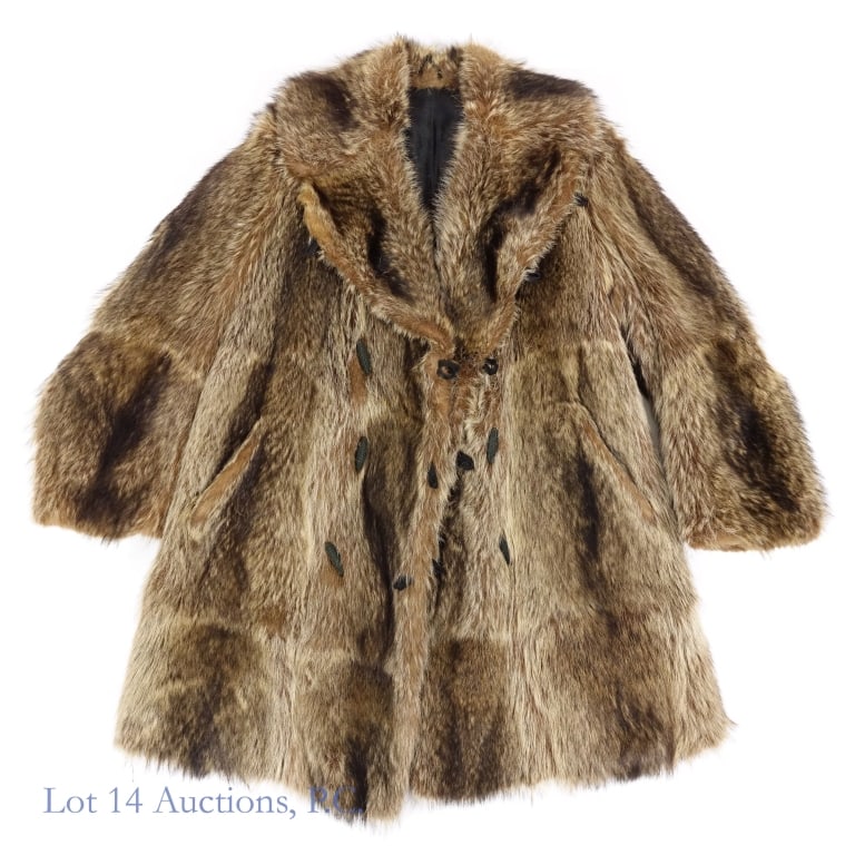 Woman's Raccoon Fur Coat: Woman's raccoon coat. Manufacturer and size unknown. Leather reinforcement at top of sleeves. recessed ribbed cuffs for added warmth. Jacket length approximately 38". Top-to-Top approximately 18". Sle