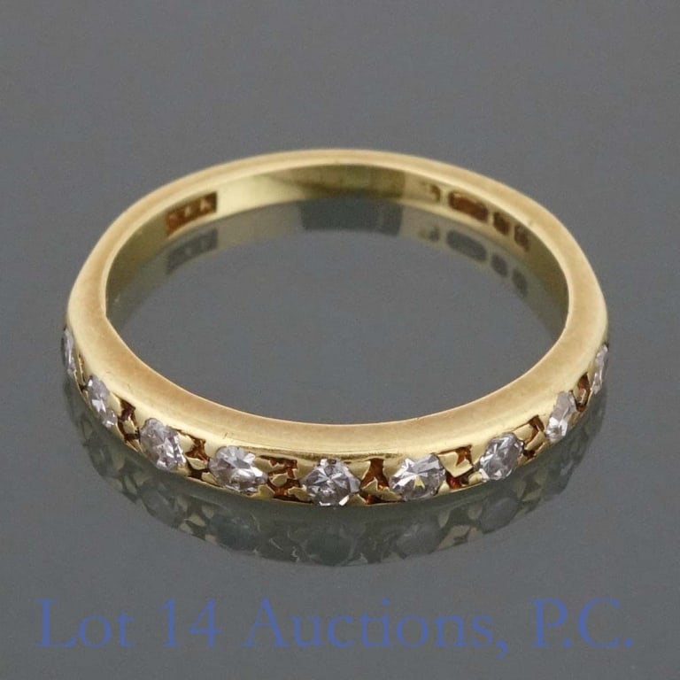 18k Y Gold Sapphire Ring: Yellow gold ring. Markings are obscured, but some letters may be Cyrillic. Tests electronically as 18 karat gold. 9 stones electronically test as sapphire. Size: 4.5. Weight: 1.75 grams.