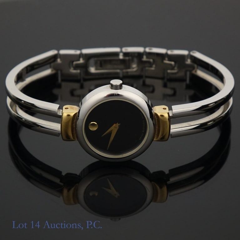 Movado Sapphire Crystal Stainless Steel Watch: Movado Sapphire Crystal Stainless Steel Watch. Model 06 3 20 1014. Two toned with a black dial. With original box, but missing the outer layer. Seems to be a few small scratches on the band. The dial